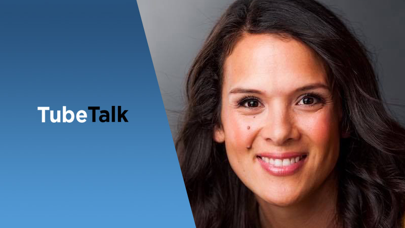 Smiling woman with dark hair next to TubeTalk logo on blue and gray background