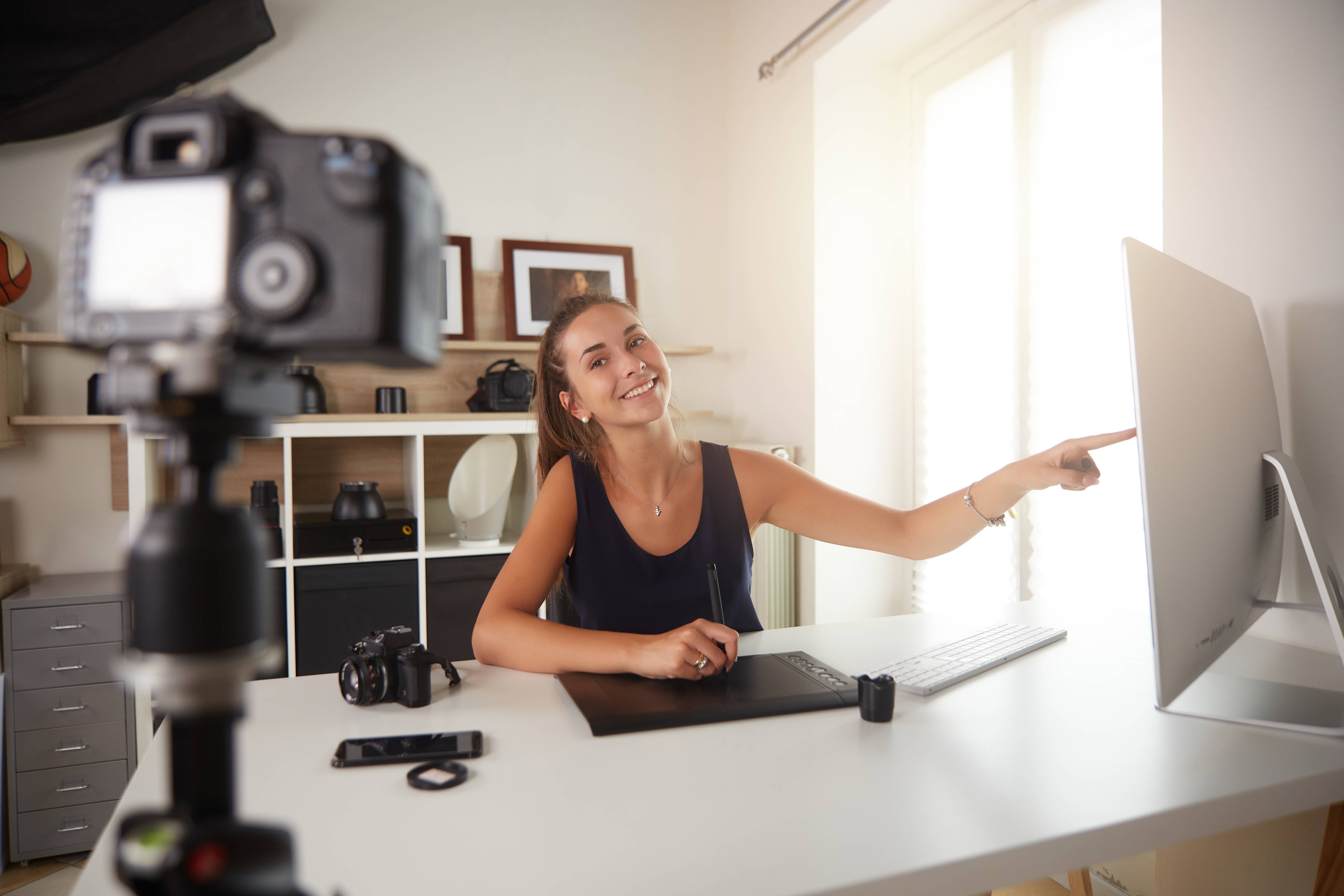 Woman shooting content on high end camera