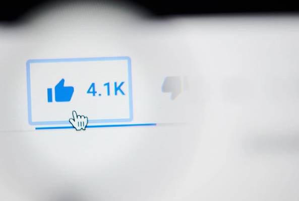 Cursor hovering over blue thumbs-up like button with 4.1K likes on digital interface