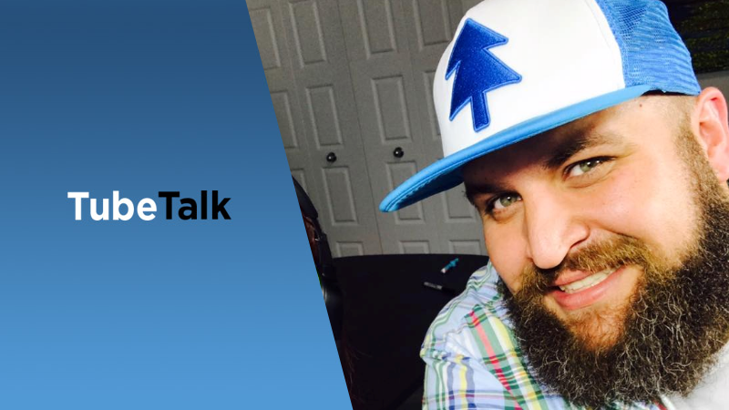 Smiling man with beard wearing blue and white hat next to TubeTalk logo on blue background