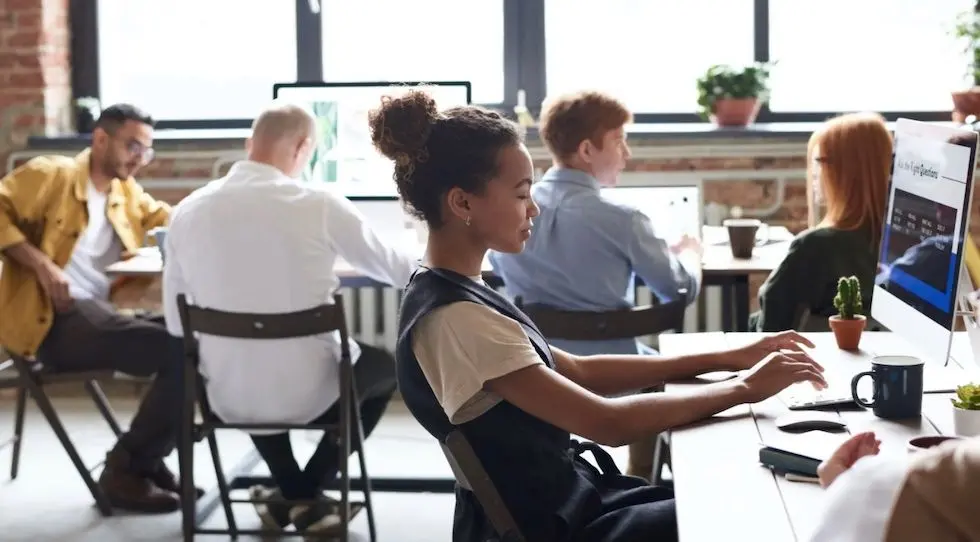 A woman typing on a computer keyboard