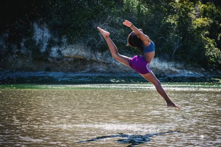 a woman dancing at the ocean