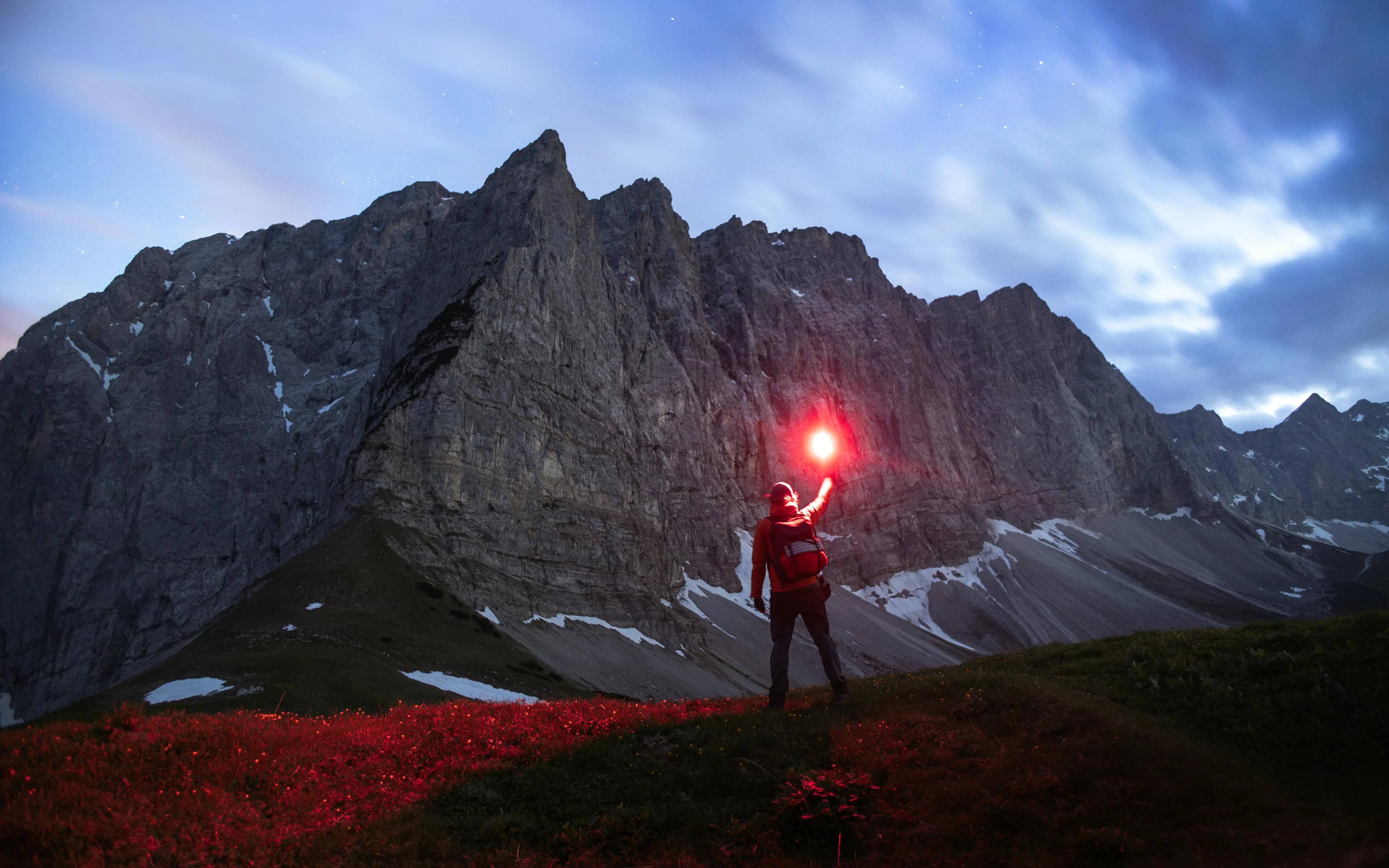 someone alone on a mountain with a flare | Quandary Consulting Group