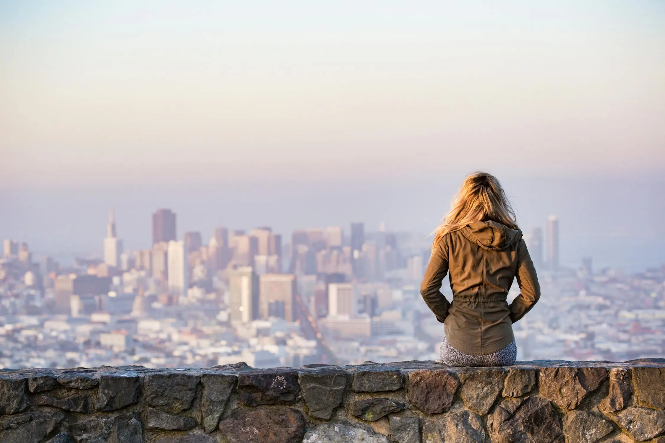 a woman facing the city view