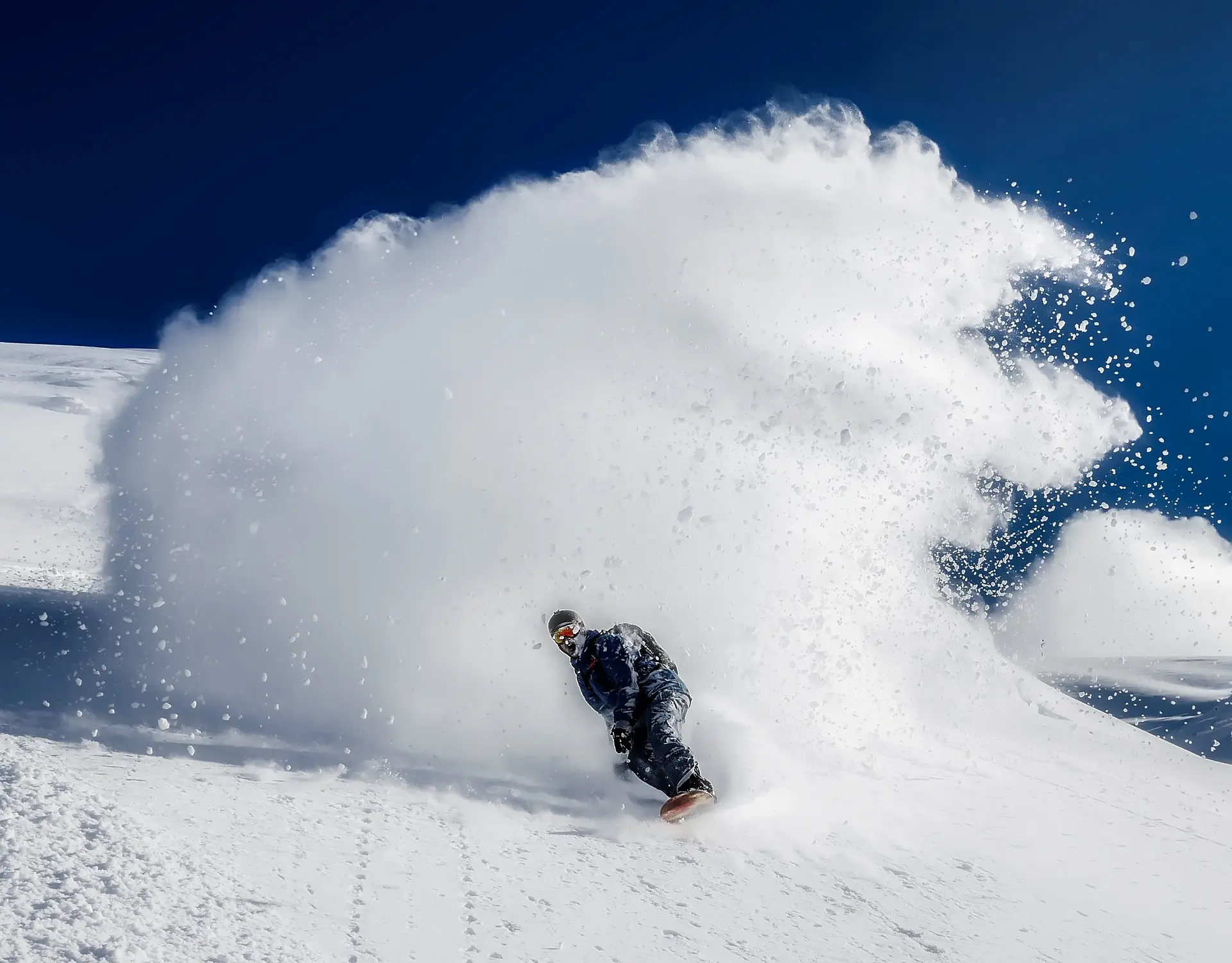 Someone snowboarding down a mountain fast | Quandary Consulting Group