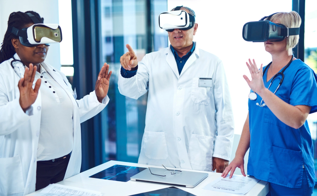 a group of doctors using a virtual reality goggles in a doctor office