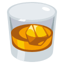 Tumbler glass filled with amber whiskey or bourbon on ice.