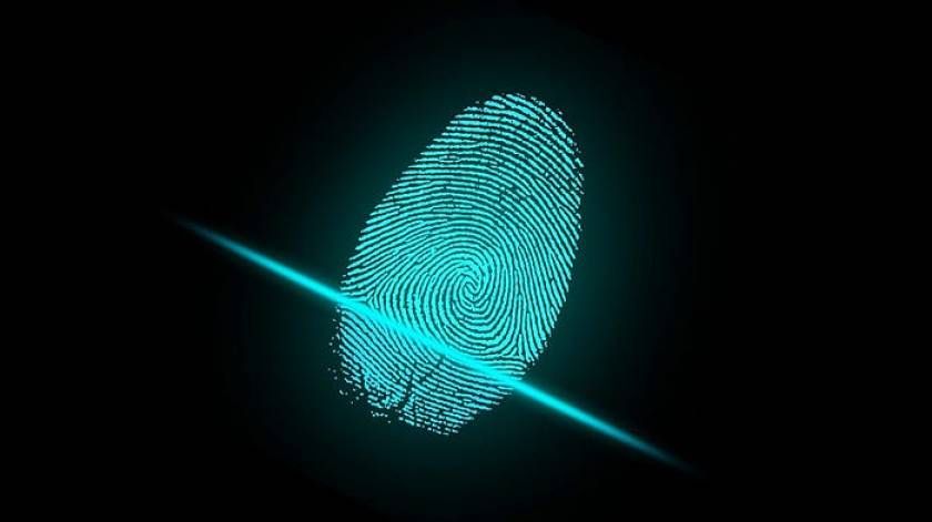 Glowing cyan fingerprint with digital scan lines on dark background representing biometric security and identity verification.
