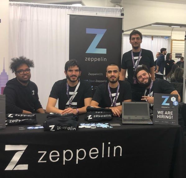 Zeppelin team members at booth with logo banner and "We Are Hiring" sign at conference or trade show.