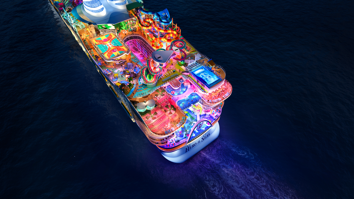 An aerial view of a vibrant cruise ship illuminated at night, featuring various entertainment areas such as water slides, pools, and colorful attractions. The scene captures the lively atmosphere of a modern cruise experience on open water.