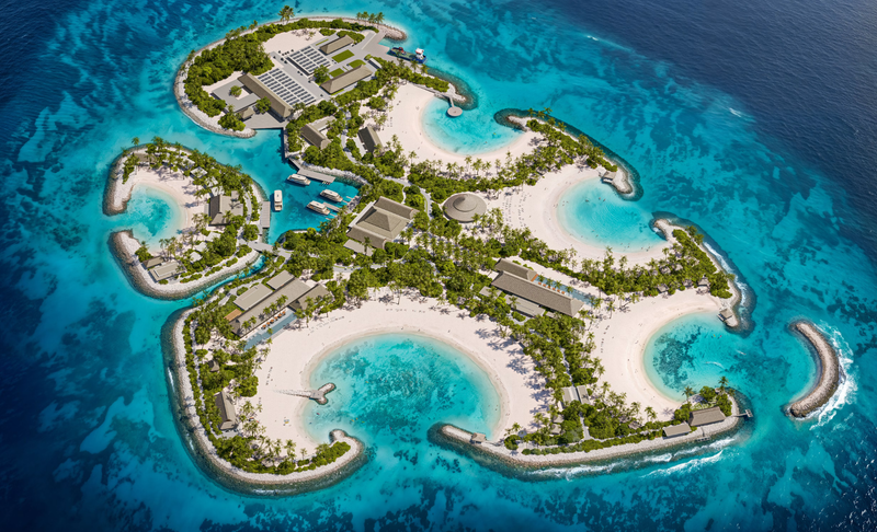The image showcases an aerial view of a tropical resort island surrounded by turquoise waters. The island features several white sandy beaches, lush greenery, and various luxury accommodations.