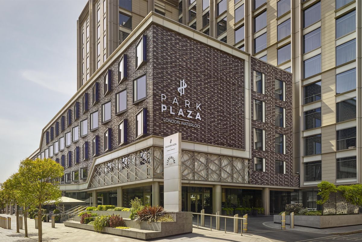 The image shows the exterior of the Park Plaza London Westminter hotel. The modern architecture is highlighted by a prominent entrance and detailed facade.