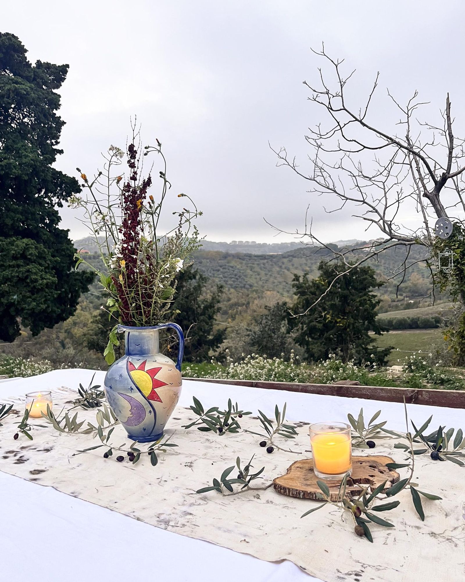 Table set with food and drinks overlooking the hills at Sentieri