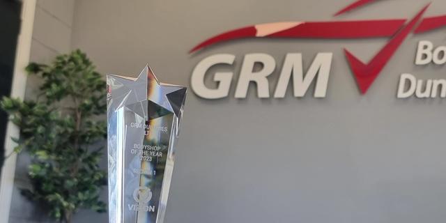 Vizion award trophy with GRM logo in the background