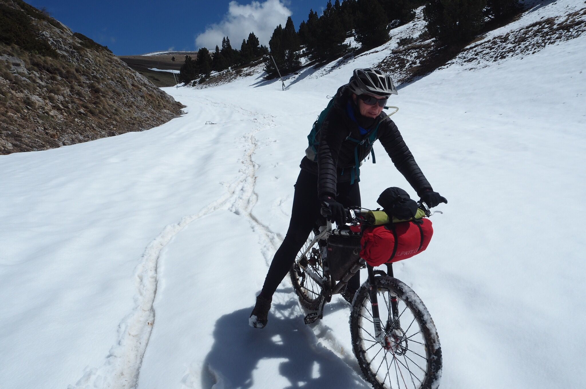 Just in case any of you have been wondering (&#8230;and I&#8217;m guessing you all have). Pushing a fully laden touring mountain bike up hill to 2145mtrs above sea level to then try and ride it down a series of partially snow covered ski slopes that sit on top of some very slippery scree is, without [&hellip;]