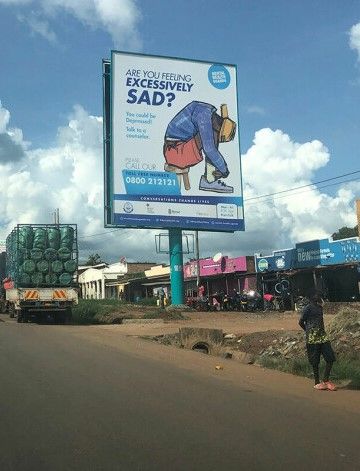 Advertising poster for the helpline in a street in Uganda
