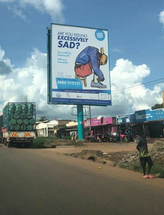 Advertising poster for the helpline in a street in Uganda