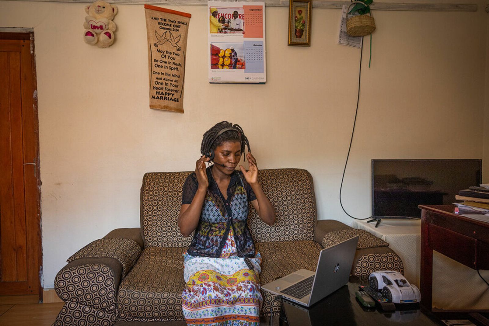 A counsellor taking a call for the free helpline in Uganda