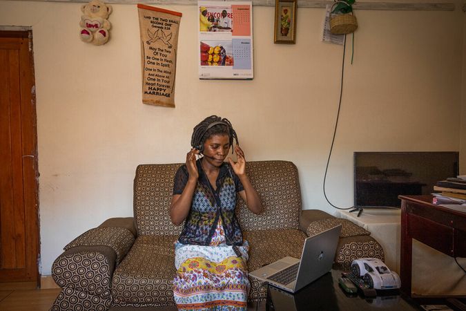 A counsellor taking a call for the free helpline in Uganda