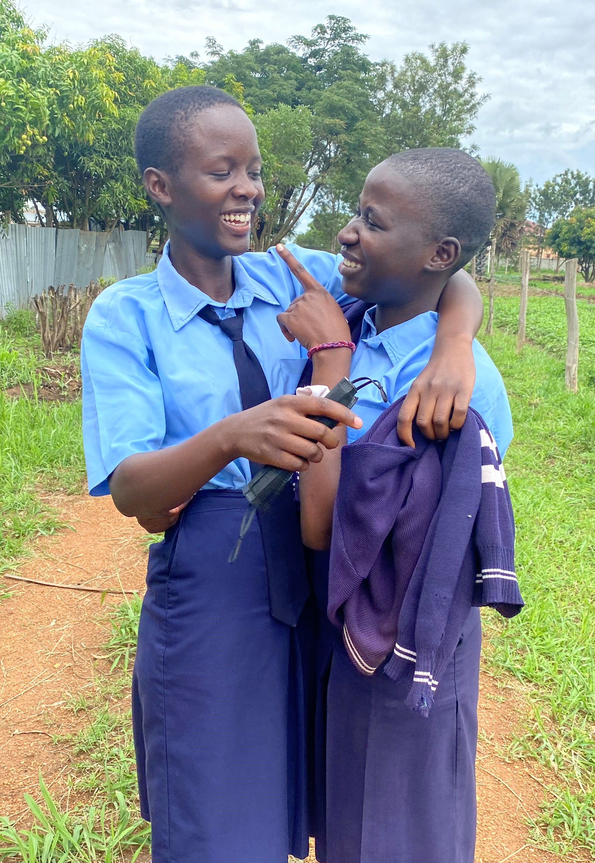 Two students smiling in Gulu, Uganda