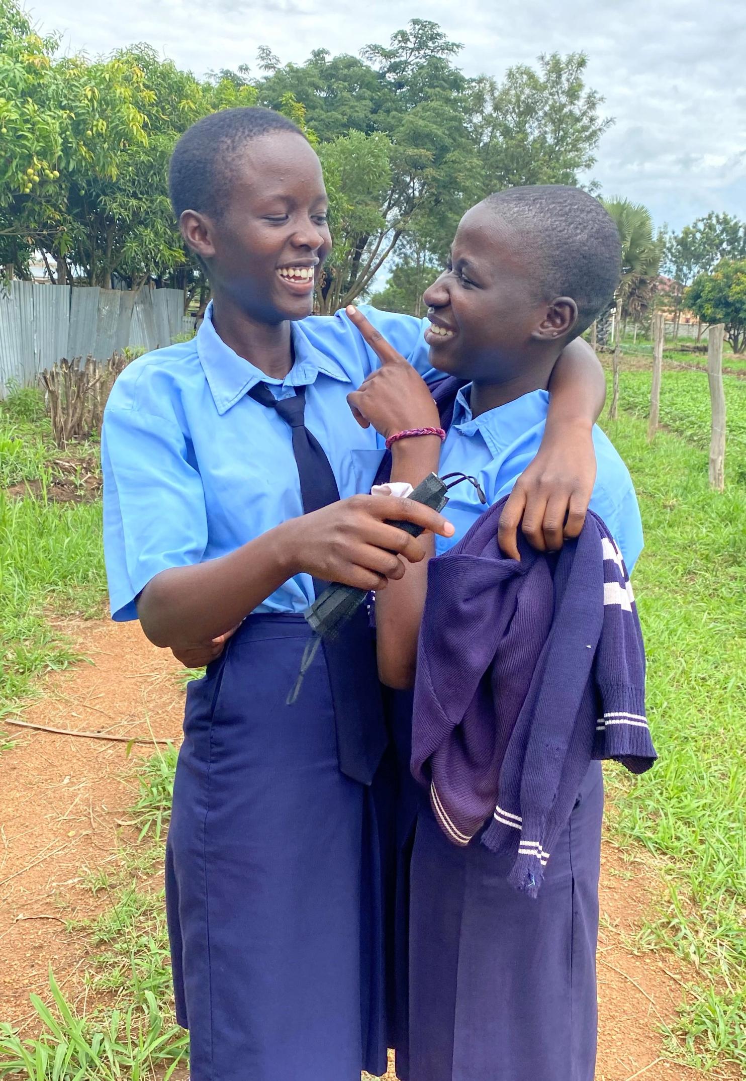 Two students smiling in Gulu, Uganda