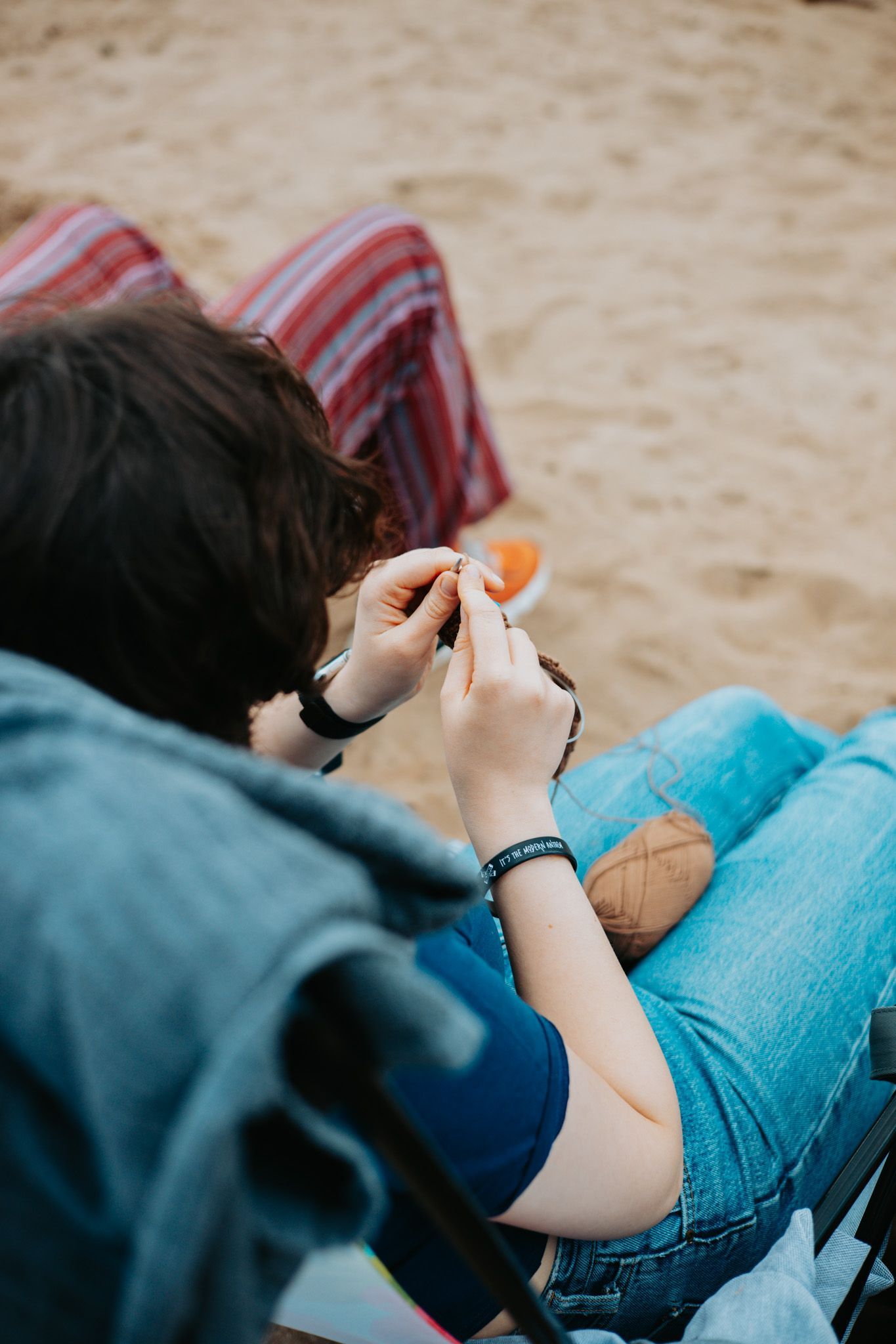 Person sett bakfra som sitter og hekler