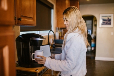 Woman making homemade coffee in her kitchen