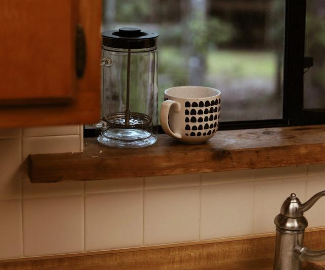 French Press Stored Near a Kitchen Window