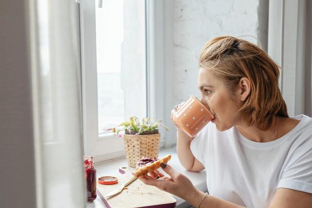 Woman Enjoying Morning Coffee and Breakfast