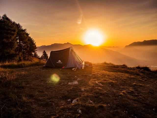 Tent on a Mountaintop with the Sun in the Background