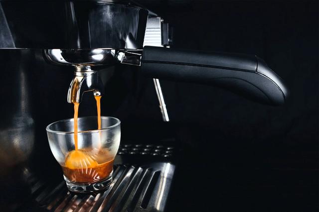 Espresso flows out from an espresso machine