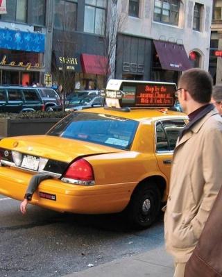 a man is standing in front of a taxi that says stop by the new york school