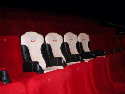 a row of audi seats in a movie theater .