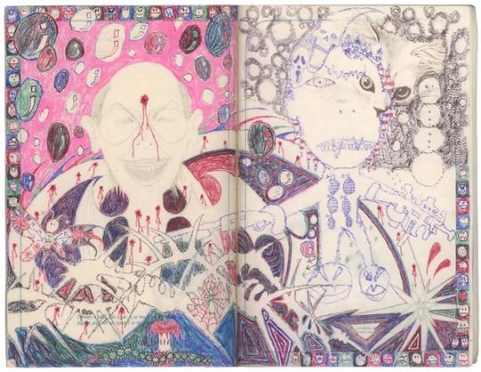a colorful drawing of a man 's face and a woman 's face in a notebook .