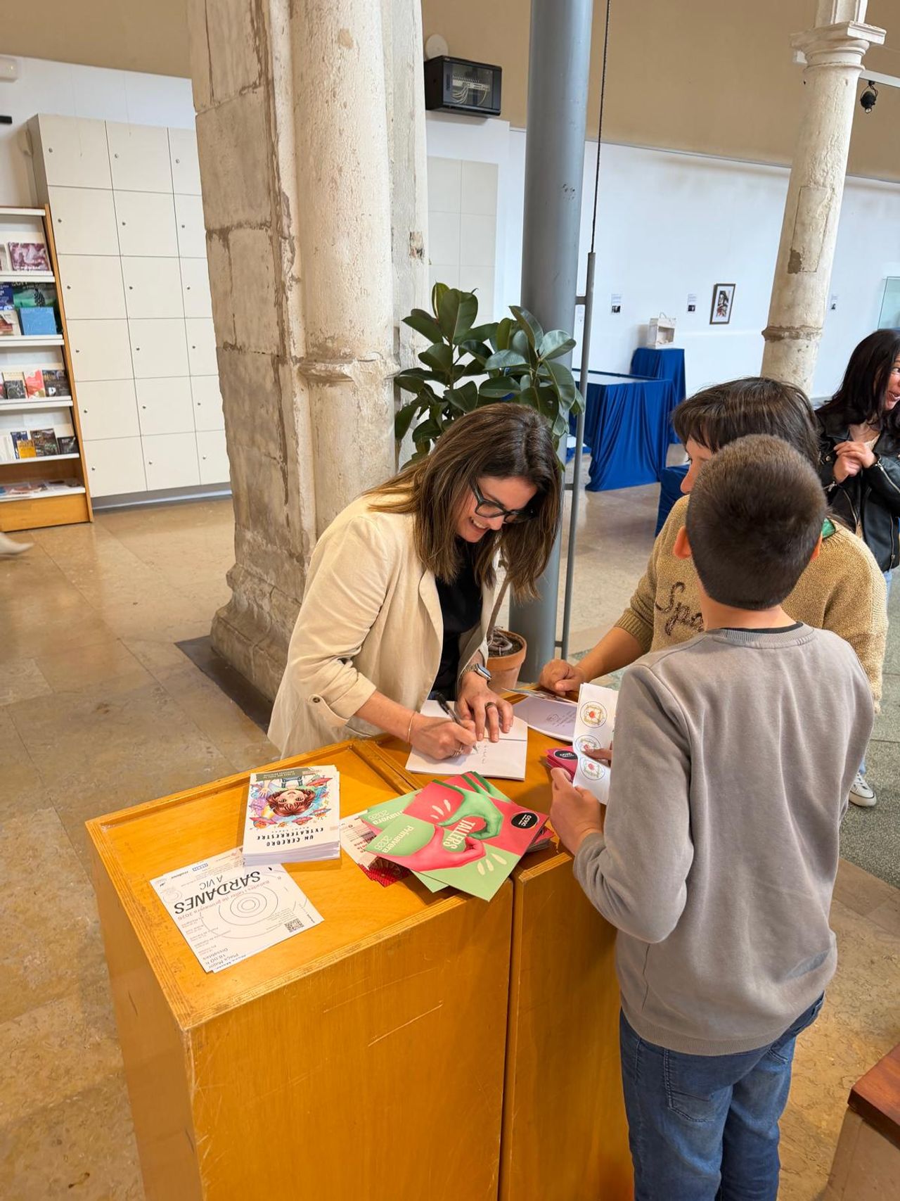 La autora firmando dedicatorias en los libros