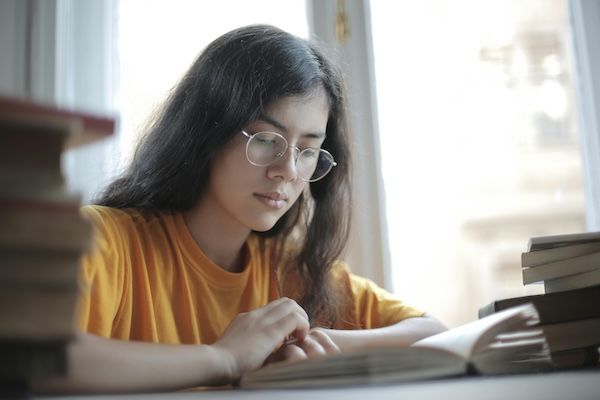 Picture is of teenage girl reading or studying. Text answers the question: Can You Take an AP Test without Taking the Class?