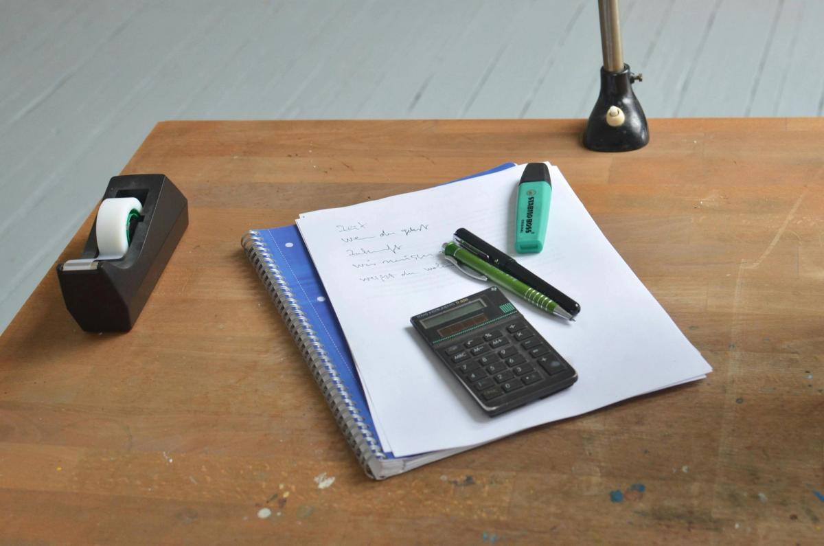 Workplace with office supplies and papers Workplace with office supplies and papers