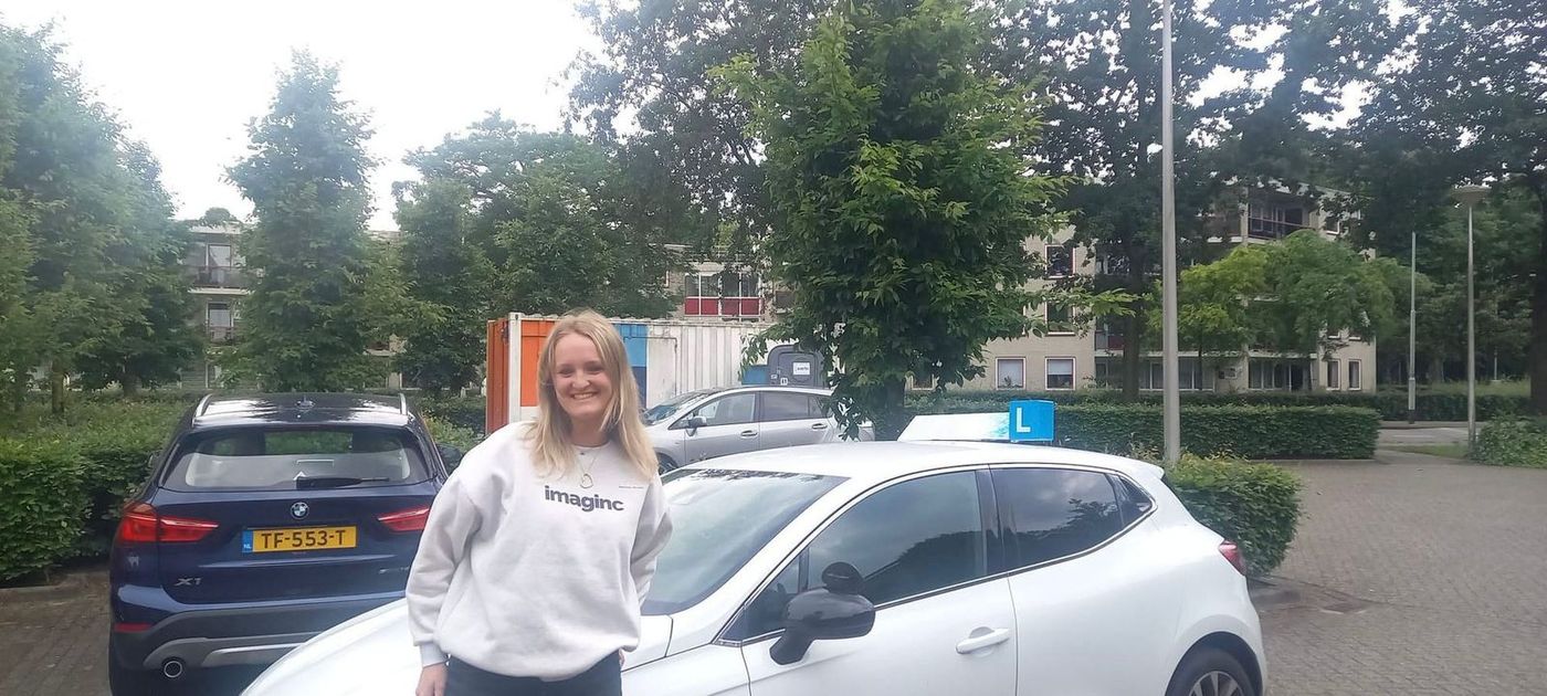 Geslaagde leerling bij de lesauto van Rijschool de Baronie in Breda