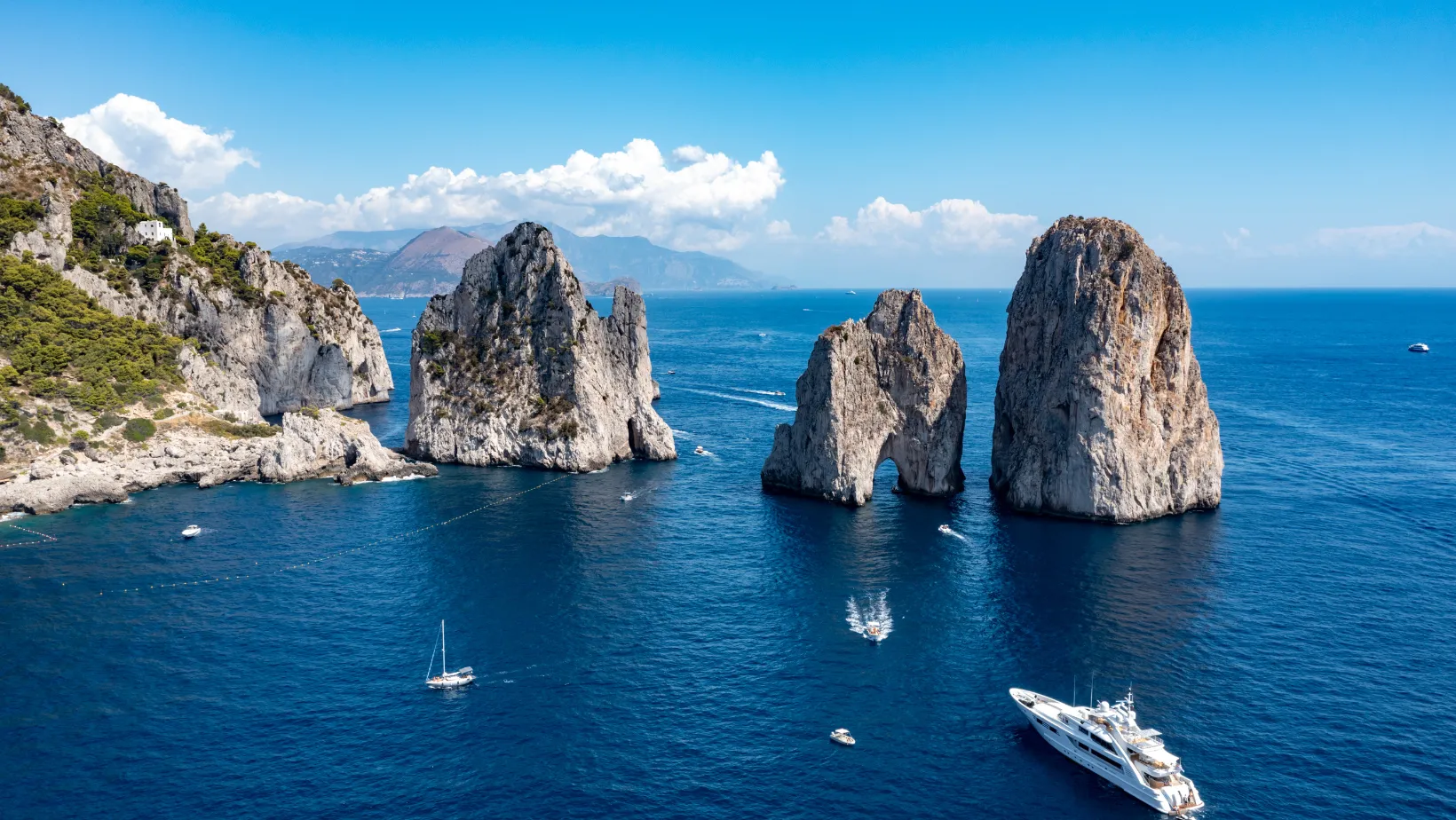 Luxury yacht near the Faraglioni rocks off Capri, Italy