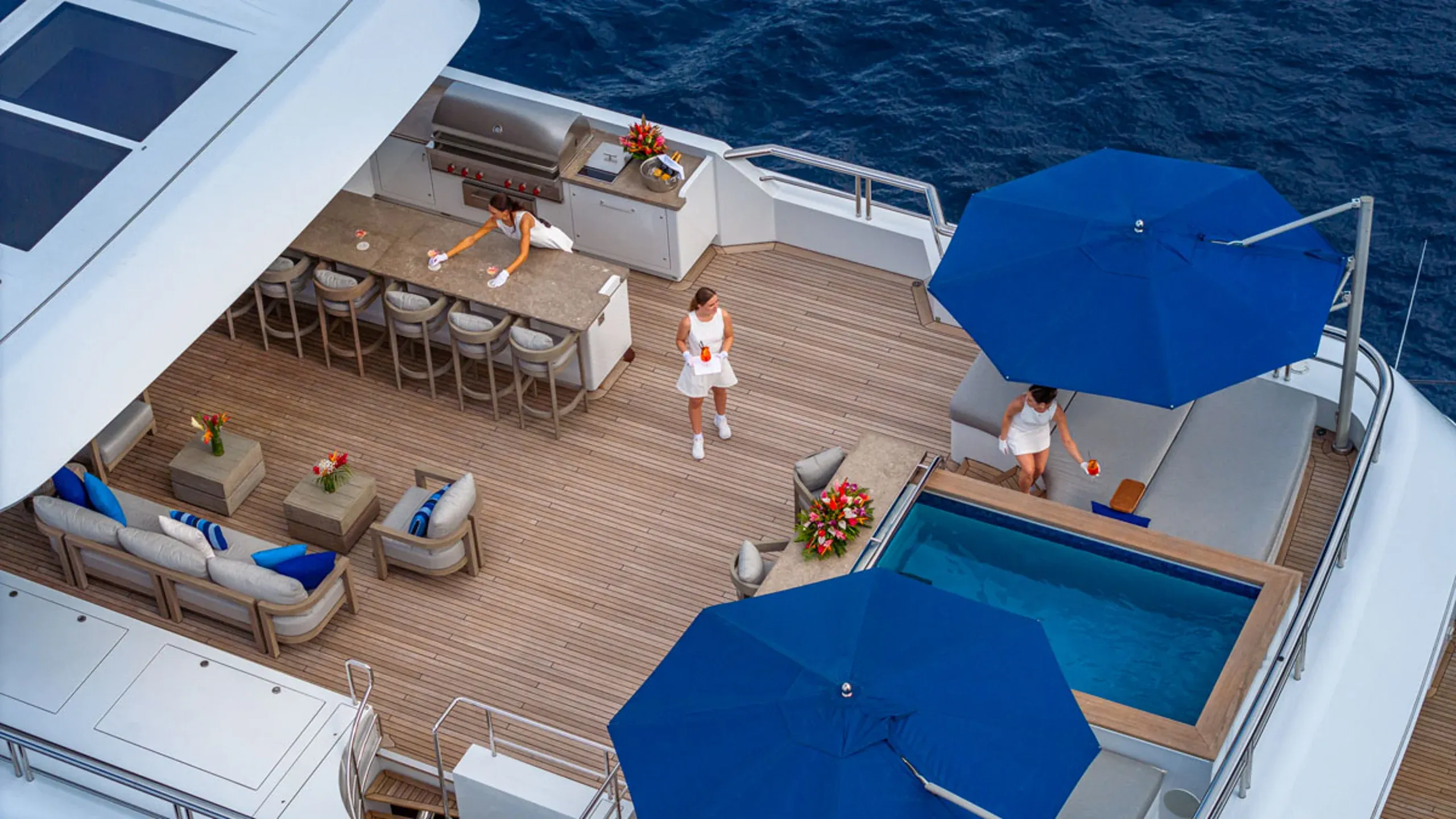 Yacht crew preparing an outdoor setup during a private charter
