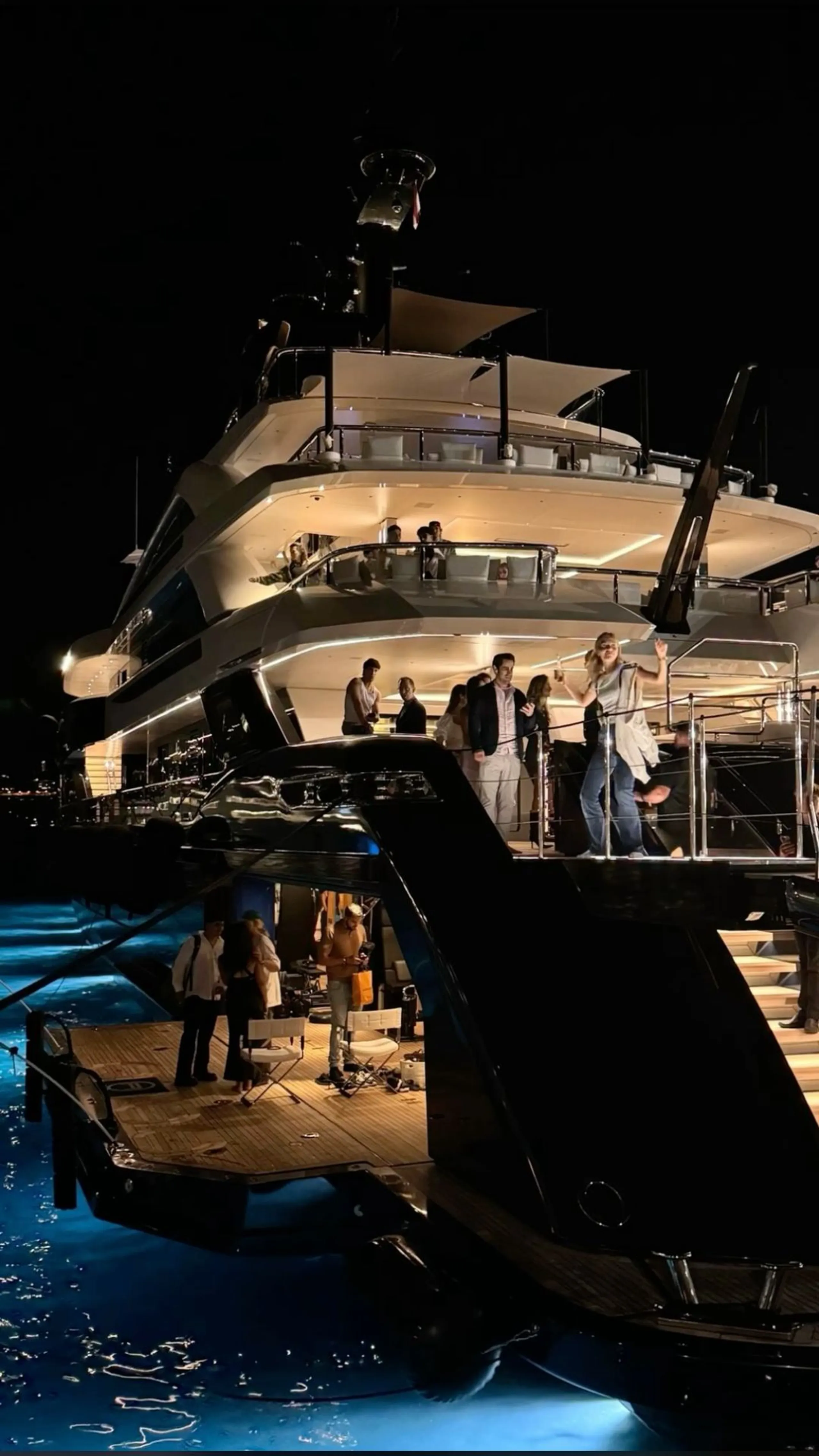 Evening reception on board a luxury yacht with guests on deck
