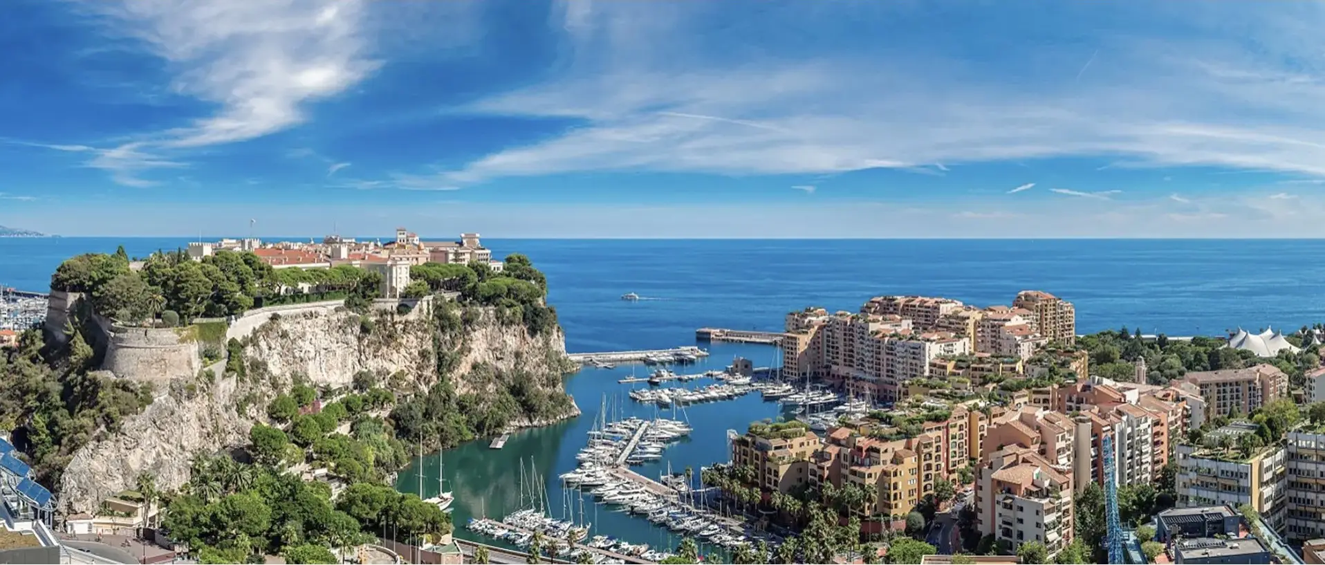 Aerial view of a Mediterranean coastline with yachts at anchor in the bay
