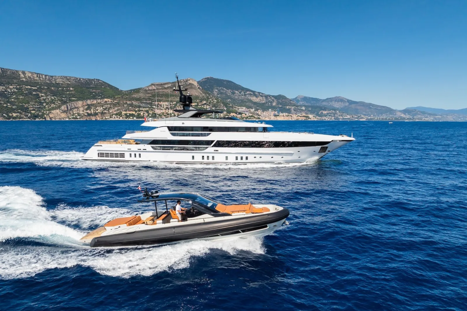 Tender approaching a superyacht during a private yacht brokerage viewing