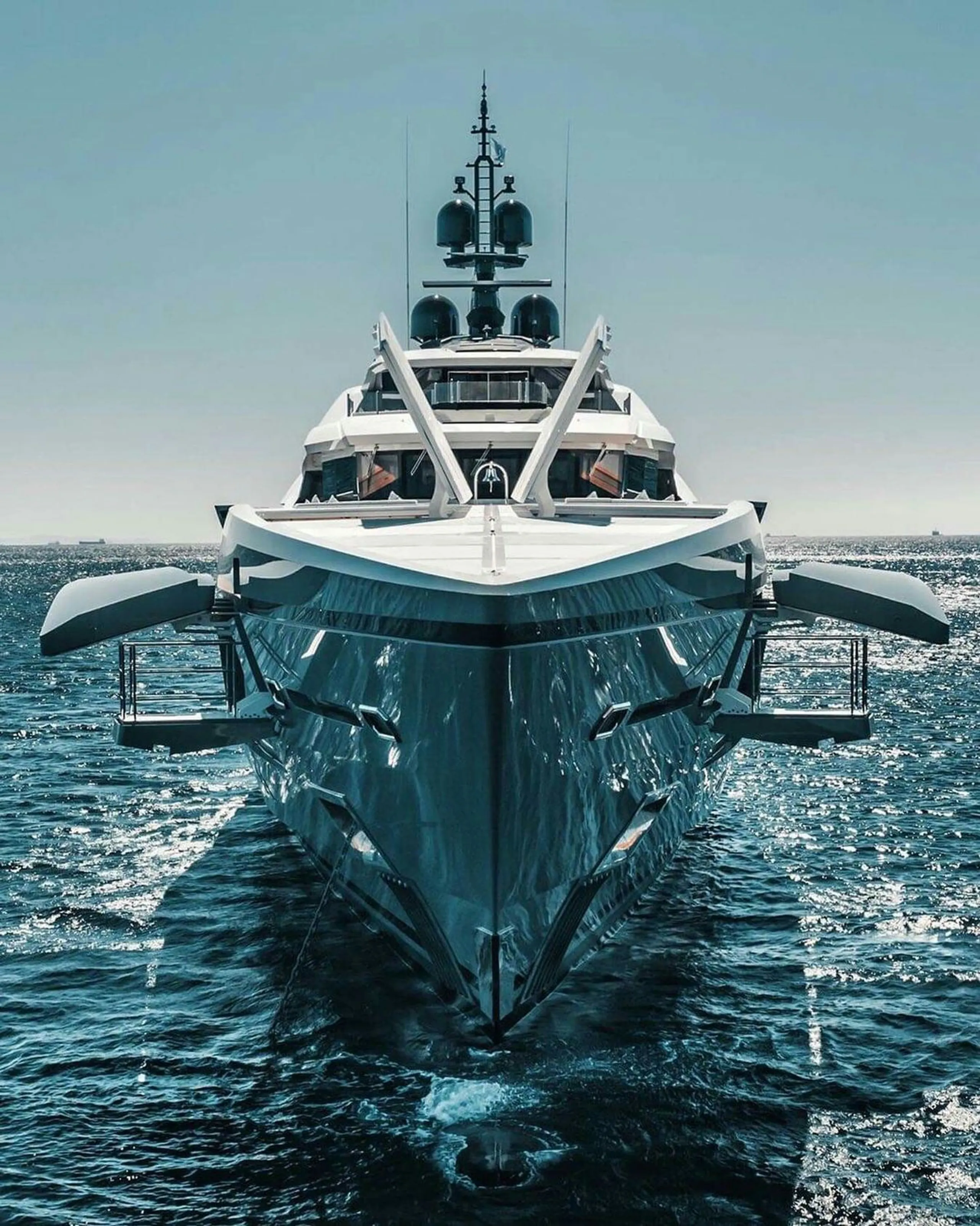 Large superyacht bow underway on open water
