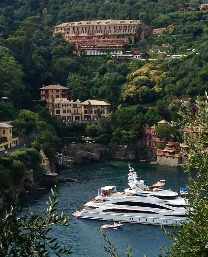 Superyacht anchored in an Italian Riviera bay surrounded by coastal villas