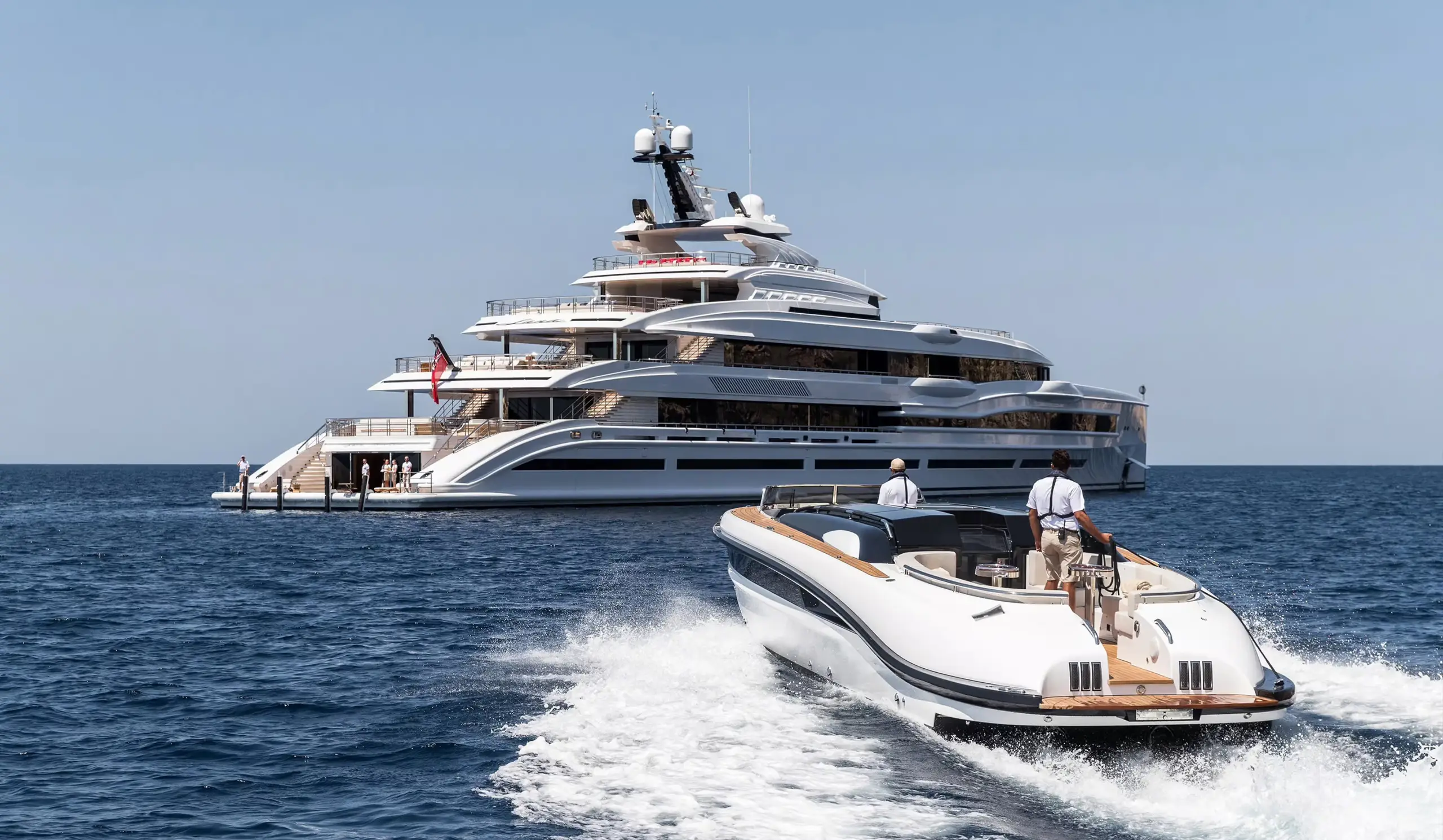 Tender approaching a superyacht at sea