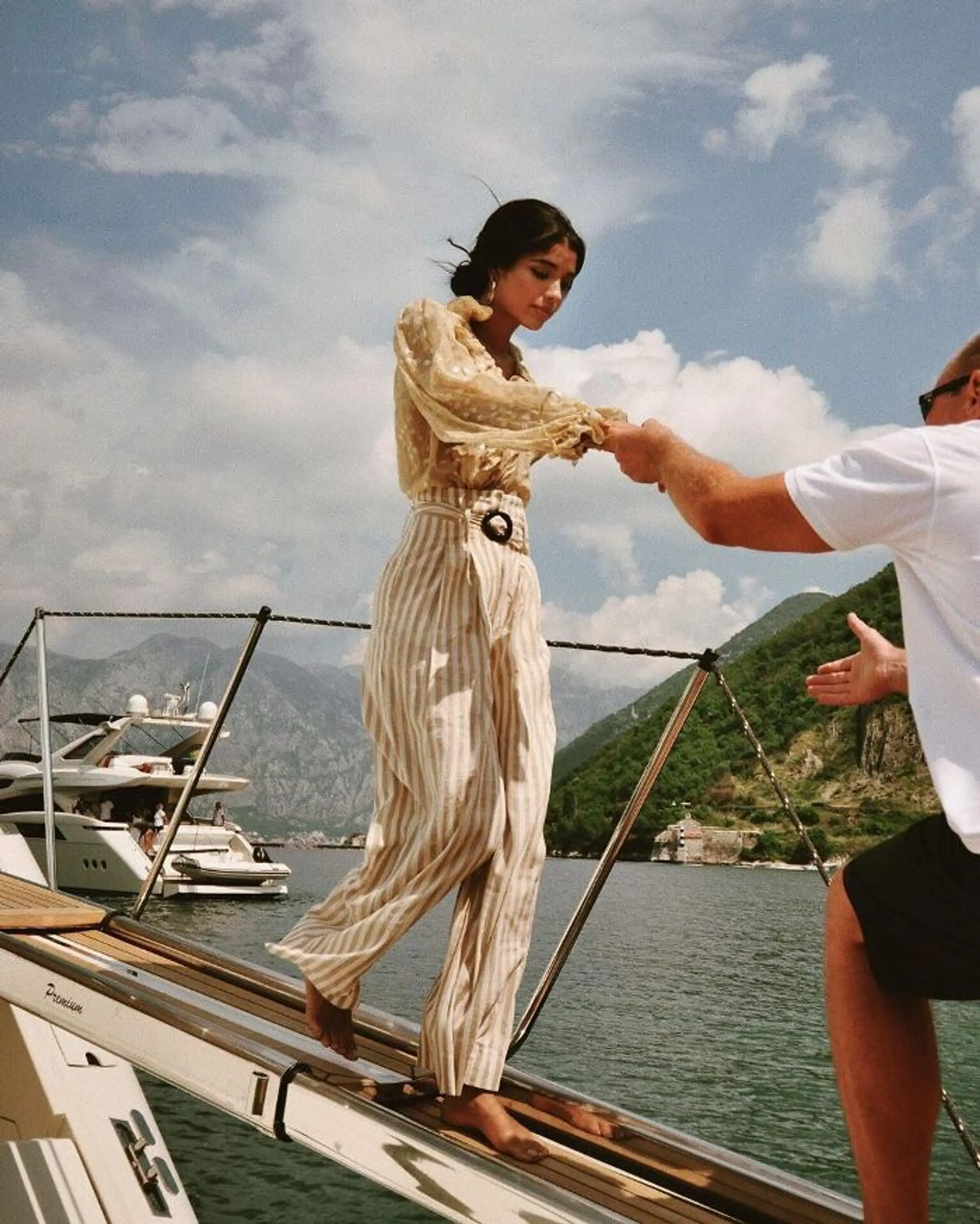 Guest being assisted while boarding a private yacht