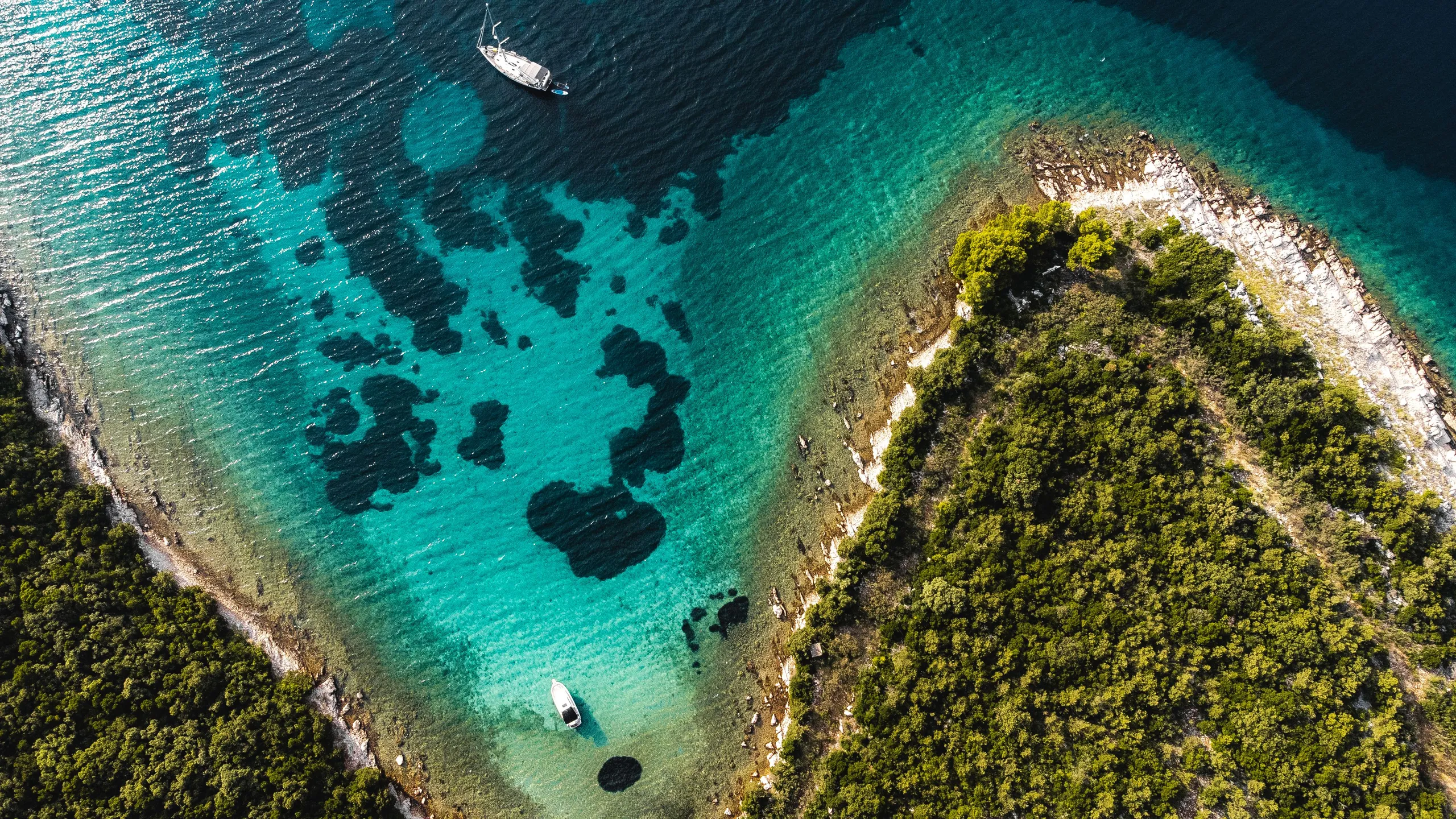 Sailing yachts anchored between islands along the Croatian coast