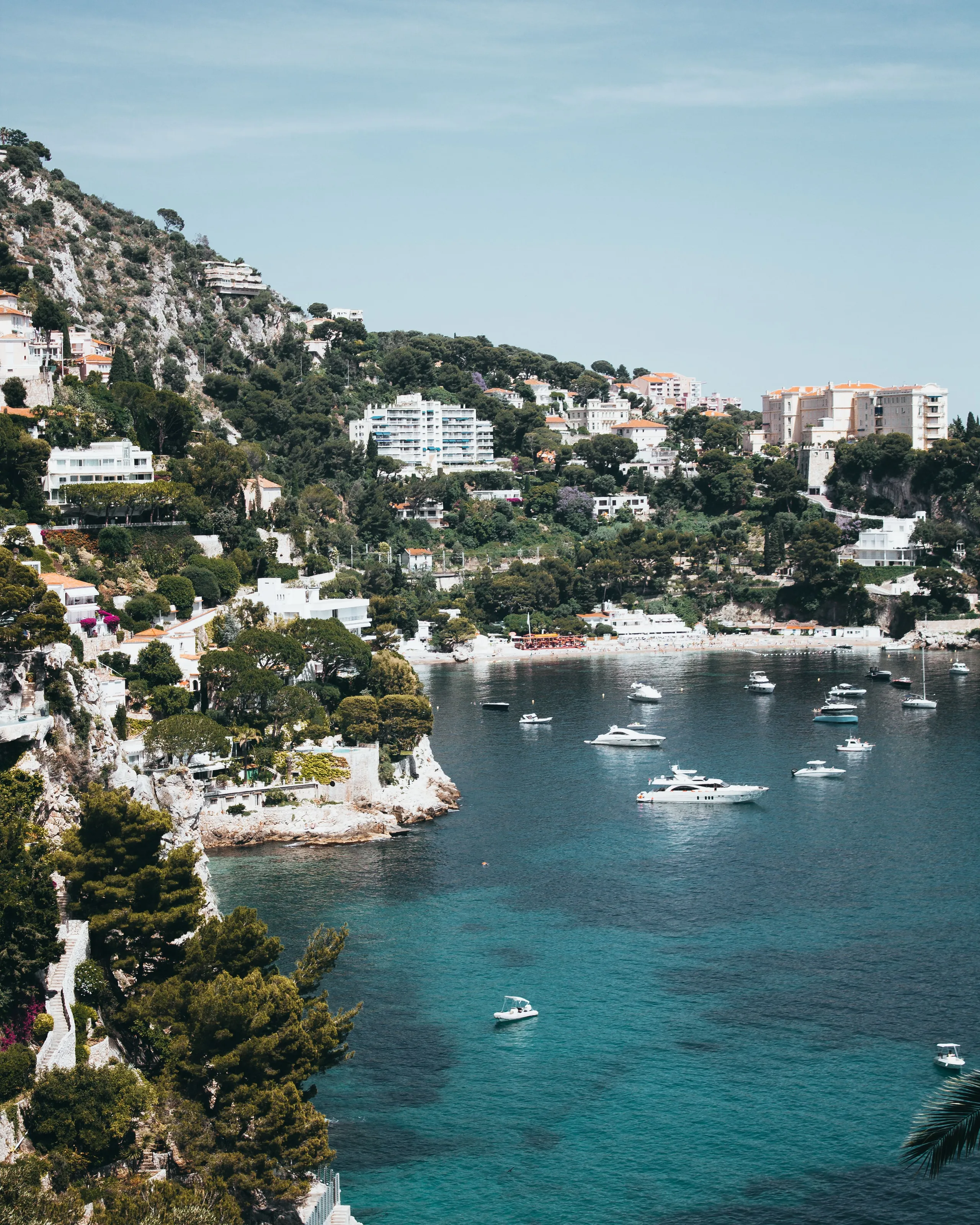 Yachts anchored in a turquoise bay on the French Riviera coastline