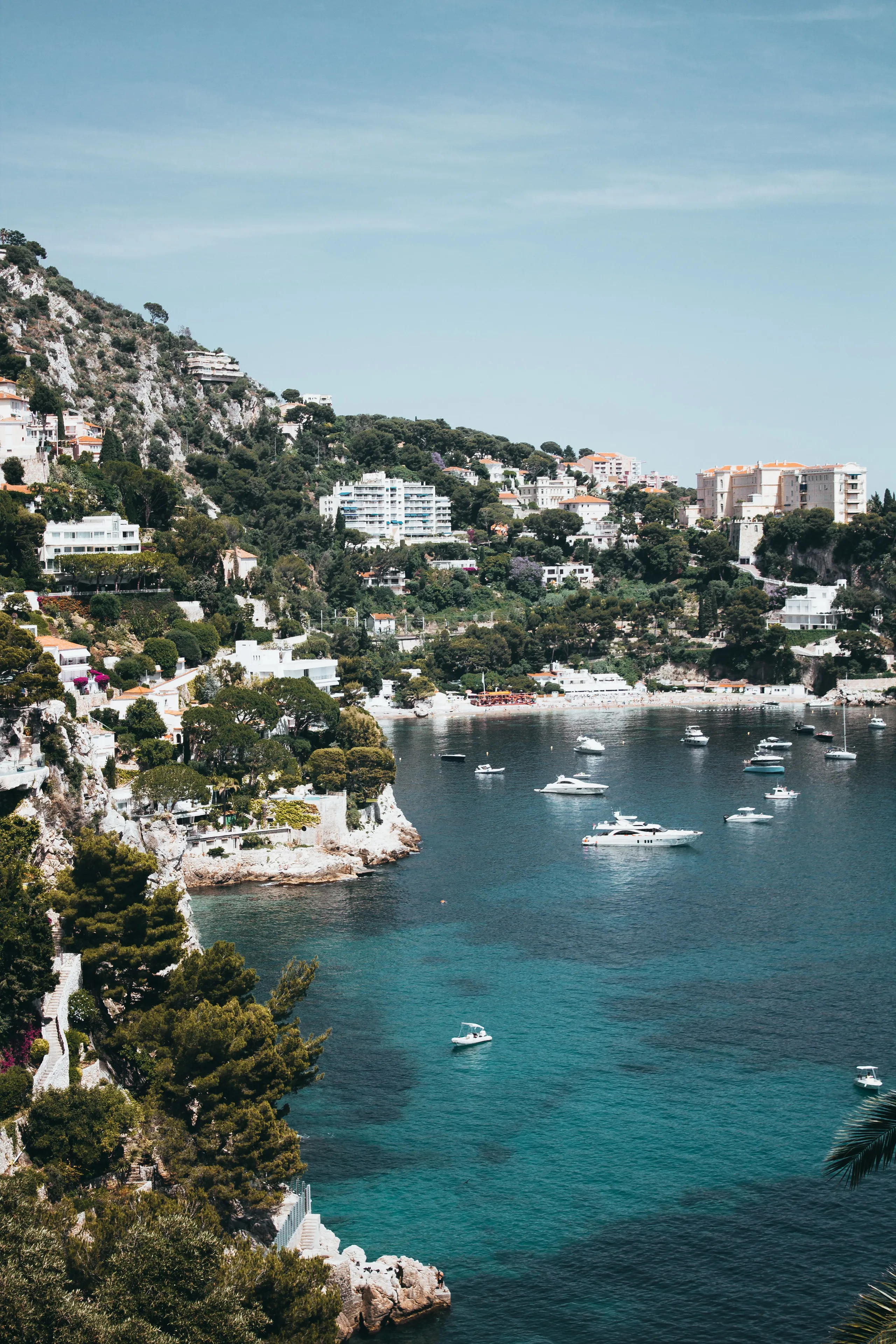 Yachts anchored in a turquoise bay on the French Riviera coastline